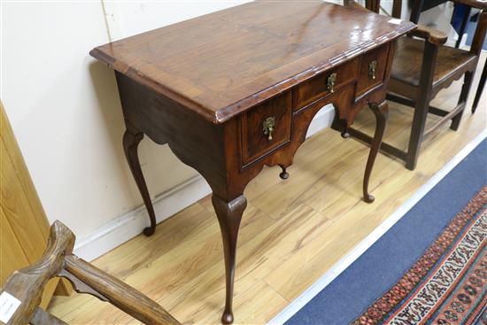 An early 18th century and later walnut and feather banded lowboy 84cm